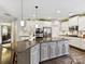 Kitchen with large center island, seating, stainless steel appliances, and hardwood floors at 105 Beech Bluff Dr, Mount Holly, NC 28120