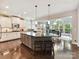 Spacious kitchen with center island, breakfast bar, stainless steel appliances, and hardwood floors at 105 Beech Bluff Dr, Mount Holly, NC 28120