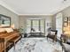 Bright living room with a bay window, neutral colors, and comfortable seating arrangement at 105 Beech Bluff Dr, Mount Holly, NC 28120