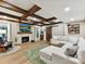 Inviting living room featuring wood beams, a fireplace, a large sectional couch, and stylish decor at 105 Beech Bluff Dr, Mount Holly, NC 28120