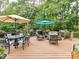 Expansive outdoor deck with seating, dining, grilling, and verdant surroundings, perfect for entertaining outdoors at 105 Beech Bluff Dr, Mount Holly, NC 28120