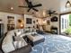 Cozy sun room featuring a large sectional, ceiling fans, and seamless indoor-outdoor living with natural light and fresh air at 105 Beech Bluff Dr, Mount Holly, NC 28120