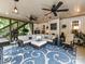 Relaxing sun room with a plush sectional sofa, ceiling fans, stylish lighting, and an eye-catching patterned rug at 105 Beech Bluff Dr, Mount Holly, NC 28120