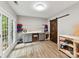 Functional work room with custom cabinets, shelving, wood floors, a sliding barn door, and natural light at 105 Beech Bluff Dr, Mount Holly, NC 28120