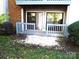 Small back patio with gray painted rails at 11010 Harrowfield Rd, Charlotte, NC 28226