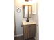 Bathroom vanity with a light wood cabinet, a modern sink, and a large mirror at 11010 Harrowfield Rd, Charlotte, NC 28226