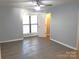 Bright bedroom with modern ceiling fan, gray walls, and window with blinds at 11010 Harrowfield Rd, Charlotte, NC 28226
