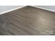 Close-up view of gray wood-look laminate flooring at 11010 Harrowfield Rd, Charlotte, NC 28226