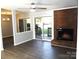 Living room featuring brick fireplace, new flooring, and access to outdoor patio at 11010 Harrowfield Rd, Charlotte, NC 28226