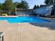 Sparkling community swimming pool with lounge chairs and a fence at 11010 Harrowfield Rd, Charlotte, NC 28226