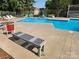 Community pool area with lounge chairs and seating at 11010 Harrowfield Rd, Charlotte, NC 28226
