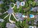 Aerial view of property showcasing the home, pool, landscaped yard, and surrounding neighborhood in a picturesque setting at 11723 Oakland Hills Pl, Charlotte, NC 28277
