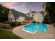 Inviting backyard with a refreshing pool and elegant landscaping, perfect for outdoor enjoyment and relaxation at 11723 Oakland Hills Pl, Charlotte, NC 28277