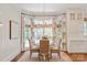 Bright breakfast nook featuring a round table and wicker chairs beneath a modern chandelier at 11723 Oakland Hills Pl, Charlotte, NC 28277