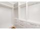 Walk-in closet featuring built-in shelving, drawers, and chrome clothing rods for ample storage at 11723 Oakland Hills Pl, Charlotte, NC 28277