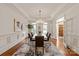 Elegant dining room with tray ceilings, chandelier lighting, and decorative wall paneling at 11723 Oakland Hills Pl, Charlotte, NC 28277