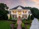 Stunning two-story home featuring classic columns, symmetrical design, and manicured landscaping at 11723 Oakland Hills Pl, Charlotte, NC 28277