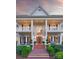 Elegant two-story home with a brick pathway leading to a covered porch and symmetrical architectural details at 11723 Oakland Hills Pl, Charlotte, NC 28277