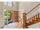 Inviting foyer with hardwood floors, staircase, and a view of the landscaped front yard through the open door at 11723 Oakland Hills Pl, Charlotte, NC 28277