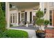 Charming front porch featuring outdoor seating, decorative plants, and classic architectural details at 11723 Oakland Hills Pl, Charlotte, NC 28277