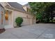 Spacious three-car garage with a concrete driveway, providing ample parking and convenient access to the home at 11723 Oakland Hills Pl, Charlotte, NC 28277