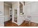 Stylish hallway bar area with a small countertop, seating, and decorative wine rack at 11723 Oakland Hills Pl, Charlotte, NC 28277
