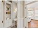 Hallway displaying white wainscoting details leading to the kitchen; showcases the home's refined style at 11723 Oakland Hills Pl, Charlotte, NC 28277
