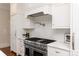 Close-up view of the stainless steel stove with white tile backsplash and pot filler at 11723 Oakland Hills Pl, Charlotte, NC 28277