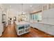 Gourmet kitchen featuring a marble island, farmhouse sink, and custom white cabinets at 11723 Oakland Hills Pl, Charlotte, NC 28277