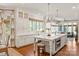 Spacious open kitchen with white cabinets, marble countertops, and stainless steel appliances at 11723 Oakland Hills Pl, Charlotte, NC 28277