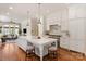 Elegant kitchen showcasing a large marble island, white cabinetry, and stainless steel range at 11723 Oakland Hills Pl, Charlotte, NC 28277
