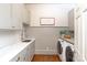 Functional laundry room with ample counter space, modern washer and dryer, and stylish decor at 11723 Oakland Hills Pl, Charlotte, NC 28277