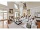 Spacious living room featuring tall ceilings, a fireplace, and elegant furnishings at 11723 Oakland Hills Pl, Charlotte, NC 28277