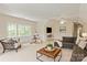 Spacious living room with a large window, a comfortable seating area, and a playful teepee in the corner at 11723 Oakland Hills Pl, Charlotte, NC 28277