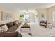 Well-decorated and spacious living room with a ceiling fan, large windows, and a comfortable seating area at 11723 Oakland Hills Pl, Charlotte, NC 28277