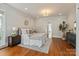 Serene main bedroom showcasing a plush bed, decorative lighting, and hardwood floors at 11723 Oakland Hills Pl, Charlotte, NC 28277