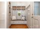 Well-organized mudroom with built-in bench, storage cabinets, and hooks, ideal for entryway storage at 11723 Oakland Hills Pl, Charlotte, NC 28277