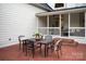 Brick patio with an elegant outdoor dining set, perfect for enjoying meals and gatherings in a charming setting at 11723 Oakland Hills Pl, Charlotte, NC 28277