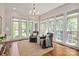 Bright sitting room with large windows, hardwood floors, and comfortable armchairs at 11723 Oakland Hills Pl, Charlotte, NC 28277