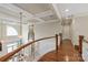 Open staircase features hardwood floors, detailed railings, and a view of the entryway with natural light at 11723 Oakland Hills Pl, Charlotte, NC 28277