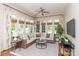 Bright sunroom filled with windows, offering a comfortable seating area and natural light at 11723 Oakland Hills Pl, Charlotte, NC 28277