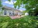Inviting backyard with a patio, outdoor furniture, grill, manicured lawn and storage shed at 11909 Creek Turn Dr, Charlotte, NC 28278