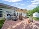 Backyard patio features a large grill, outdoor seating under an umbrella, and decorative planters at 11909 Creek Turn Dr, Charlotte, NC 28278