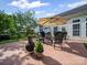 Backyard patio area with outdoor furniture, grill, and a large shade umbrella for comfortable outdoor living at 11909 Creek Turn Dr, Charlotte, NC 28278