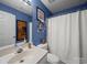 Bright bathroom featuring vanity, toilet, and shower with curtain at 11909 Creek Turn Dr, Charlotte, NC 28278