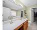 Bright bathroom with double sink vanity, large mirror, and separate tub at 11909 Creek Turn Dr, Charlotte, NC 28278