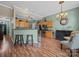 Open concept kitchen with bar seating, modern appliances, and hardwood floors at 11909 Creek Turn Dr, Charlotte, NC 28278