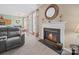 View of a living room featuring a fireplace, plush seating, and a glimpse into the dining area at 11909 Creek Turn Dr, Charlotte, NC 28278