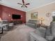 Comfortable living room featuring plush seating, ceiling fan, and modern entertainment center at 11909 Creek Turn Dr, Charlotte, NC 28278