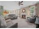 Bright and airy living room with fireplace, plush seating, and views into the eat-in kitchen at 11909 Creek Turn Dr, Charlotte, NC 28278